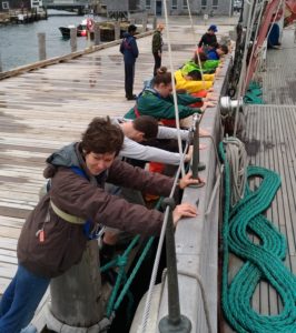 MIT/WHOI Joint Program students pushing the Corwith Cramer off the dock during the orientation cruise.